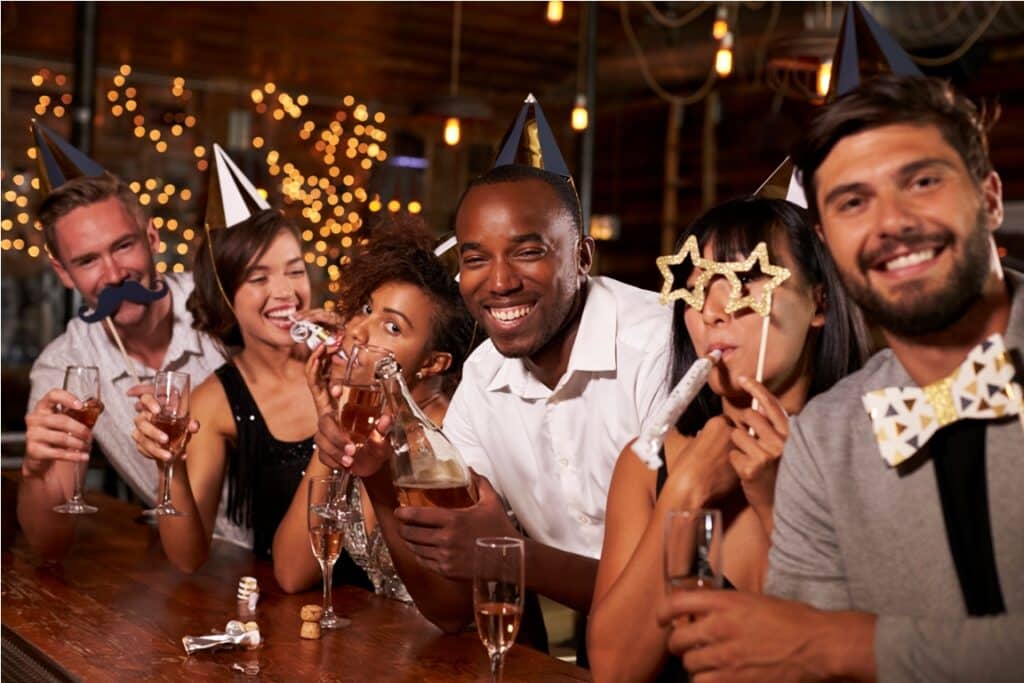 friends celebrating new year’s eve at a party in a bar