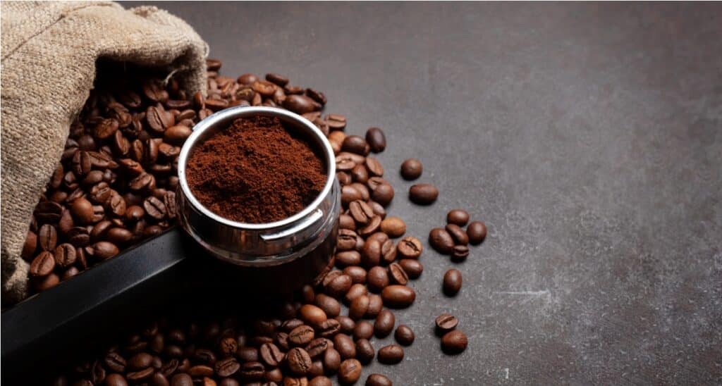 roasted coffee beans and ground coffee in filter holder