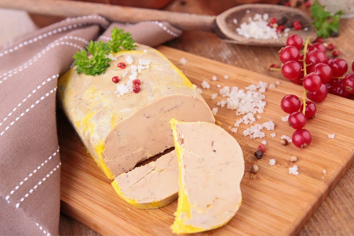 Foie gras sur planche en bois avec groseilles.