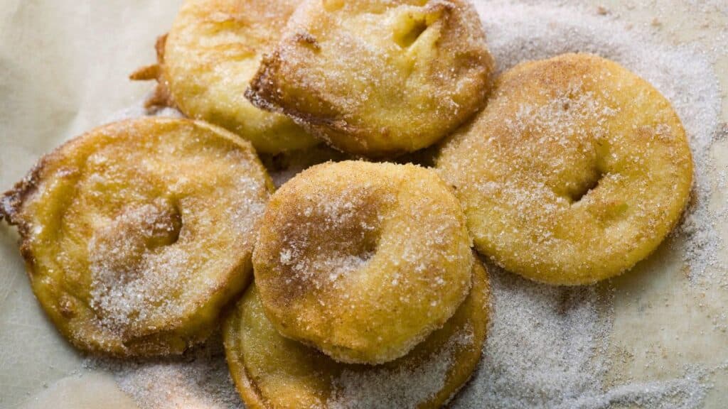 Beignets de pommes saupoudrés de sucre.