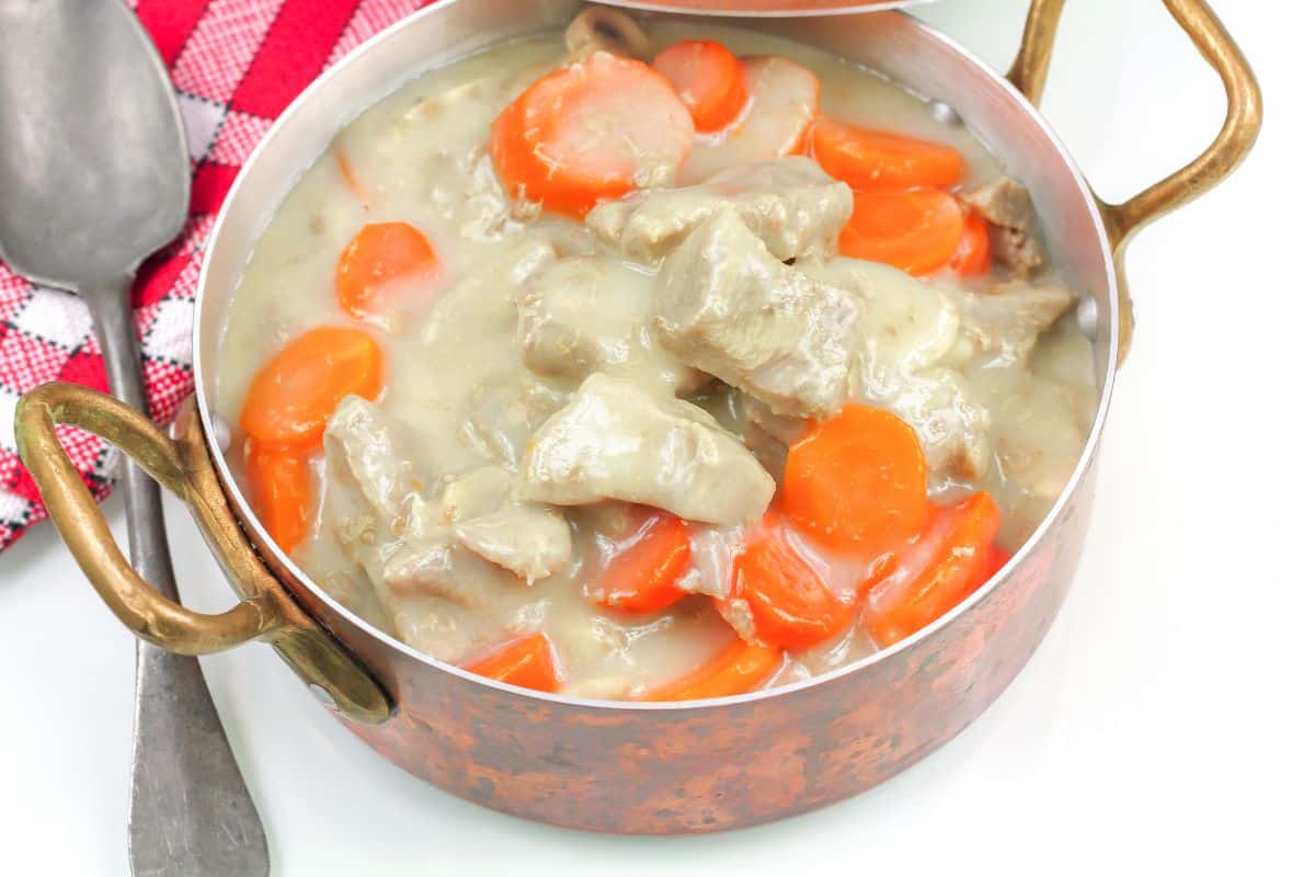 Boeuf mijoté aux carottes dans une casserole en cuivre.
