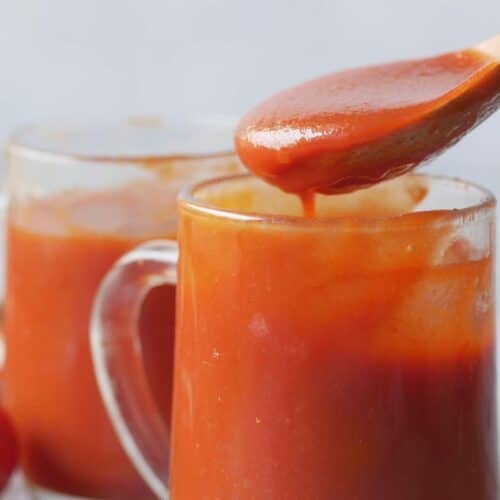 Gobelets de sauce tomate avec cuillère en bois.