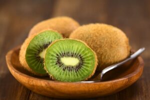 Kiwi coupé dans une assiette en bois