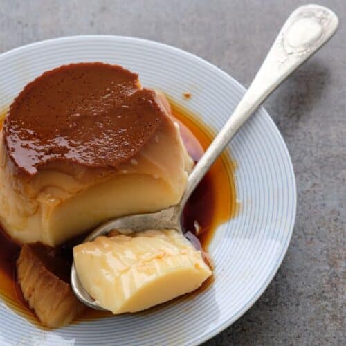 Flan au caramel dans une assiette avec cuillère.